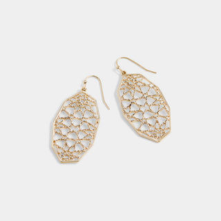 A pair of gold geometric drop earrings with an intricate openwork filigree pattern, displayed on a clean light gray background.