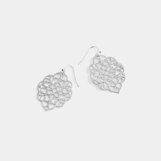 A pair of silver dangle earrings with intricate openwork floral cutout designs, displayed on a light gray background.