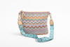 Colorful zigzag patterned handbag with a matching strap on a white background